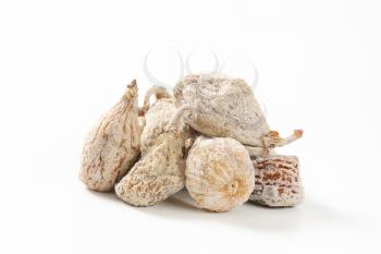 heap of dried figs on white background