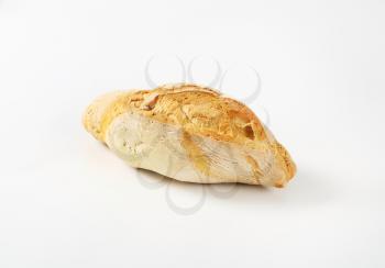 fresh diamond shaped rustic bread roll on white background