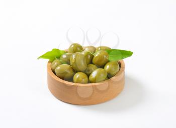 bowl of green olives on white background