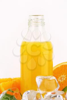 bottle of orange juice and ice cubes