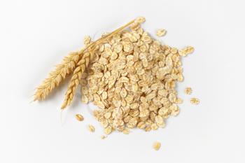 pile of oat flakes on white background