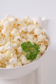 bowl of fresh popcorn on white place mat