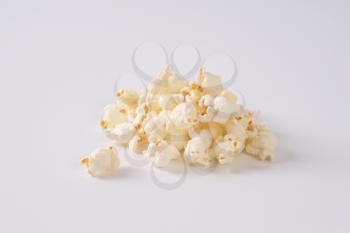 handful of fresh popcorn on white background