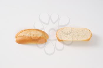 halved mini baguette on white background