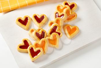 Heart shaped shortbread cookies with apricot and cherry jam filling