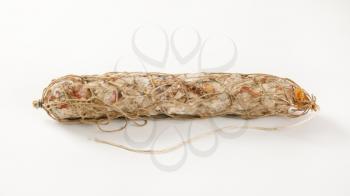 Dry cured pork sausage on white background