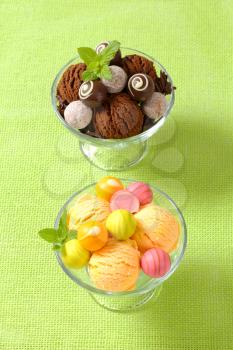 Two cups  of ice cream  with chocolate truffles and fruit-flavored pralines