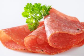 thin slices of salami with parsley