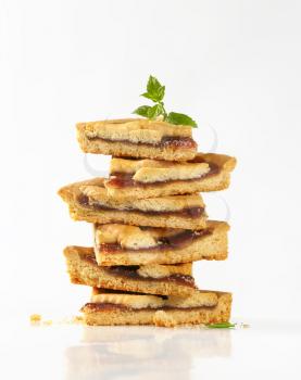stack of strawberry jam tart slices on white background