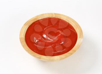 Smooth tomato puree in wooden bowl