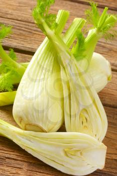 bulbs of fresh fennel on wooden background