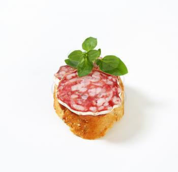 Canape with slices of French dry sausage