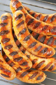 Grilled sausages on barbecue grid