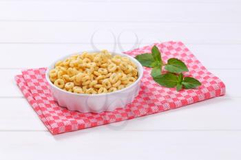 bowl of honey cereal rings on checkered place mat
