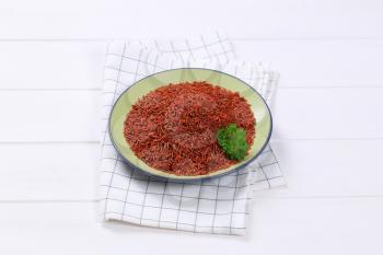 plate of red rice on checkered dishtowel