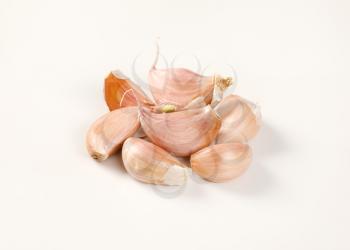 cloves of fresh garlic on white background