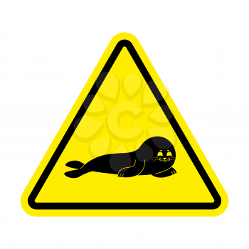 Attention Fur Seal. Caution small sea calf. Yellow triangle road sign
