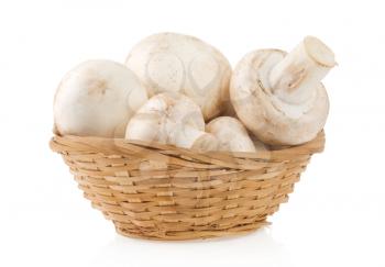 mushrooms in wicker basket isolated on white background