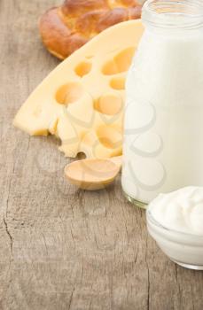 milk products and cheese on wooden background