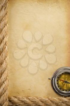 ropes and compass over old ancient paper background texture