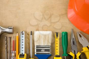 set of construction tools on wood texture background
