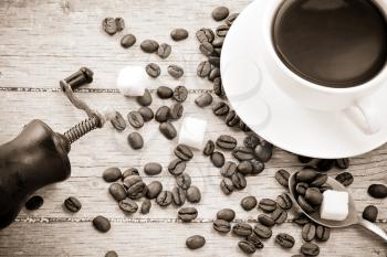 coffee beans, grinder and cup on wood texture
