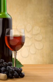 wine and glass with bottle on wood background