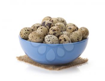 quail eggs in bowl isolated on white background