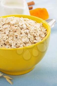 bowl of oat flake on tablecloth background