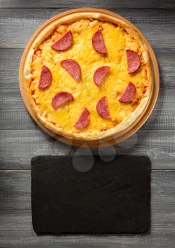 pepperoni pizza at wooden table