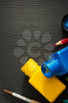 paint and bottle on wooden background
