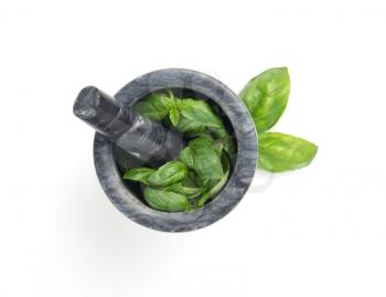 basil in mortar isolated on white background