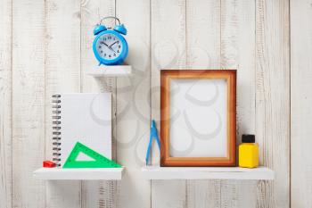 school supplies and tools on white wooden shelf