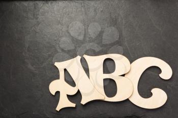 wooden letters on slate stone background