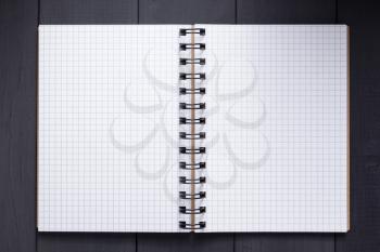 notepad or notebook at black wooden background surface table, top view