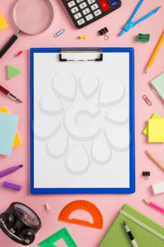 paper clipboard and school  supplies at abstract background surface