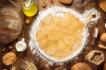 wheat flour and bakery ingredients on wooden table background