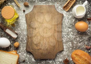 bakery ingredients on wooden background, top view