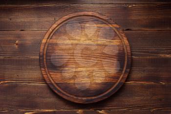 pizza cutting board or tray at wooden background texture, top view