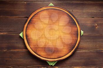 table cloth napkin and pizza cutting board on wooden background texture