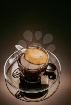 coffee in glass cup on black glossy background