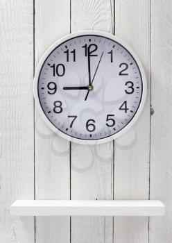 wall clock at wooden shelf background texture