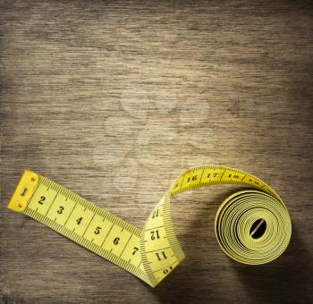 measuring tape on wooden background surface