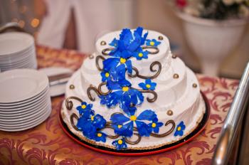 Beautiful festive pie with a pattern from dark blue flowers.
