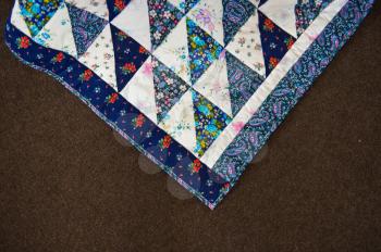 Scrappy cover of handwork with triangles.