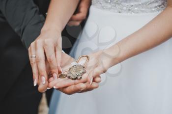 The lock in hands of the newly-married couple.