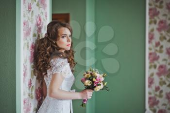 The girl with a bouquet indoors.