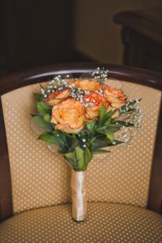 The bouquet on the chair.
