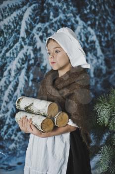 The child helps to collect firewood.