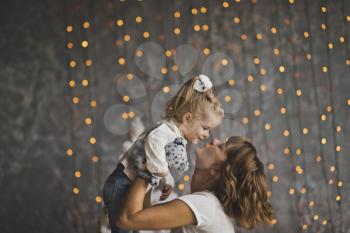 Mother throws daughter on the glittering lights.